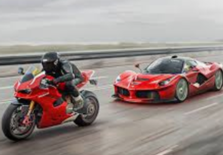 Red motorcycle racing alongside a red Ferrari supercar